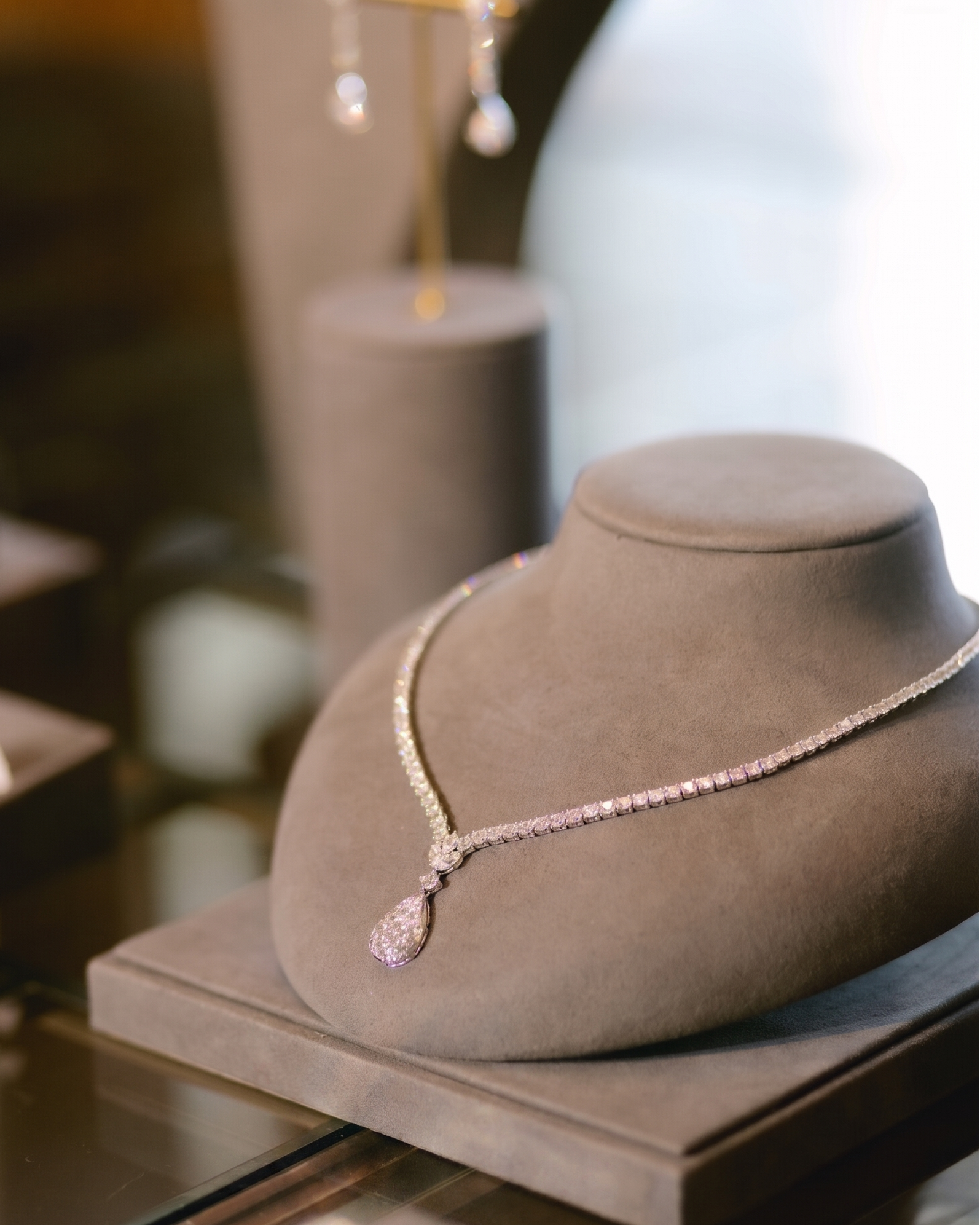 V shaped tennis necklace with pear shaped pendant