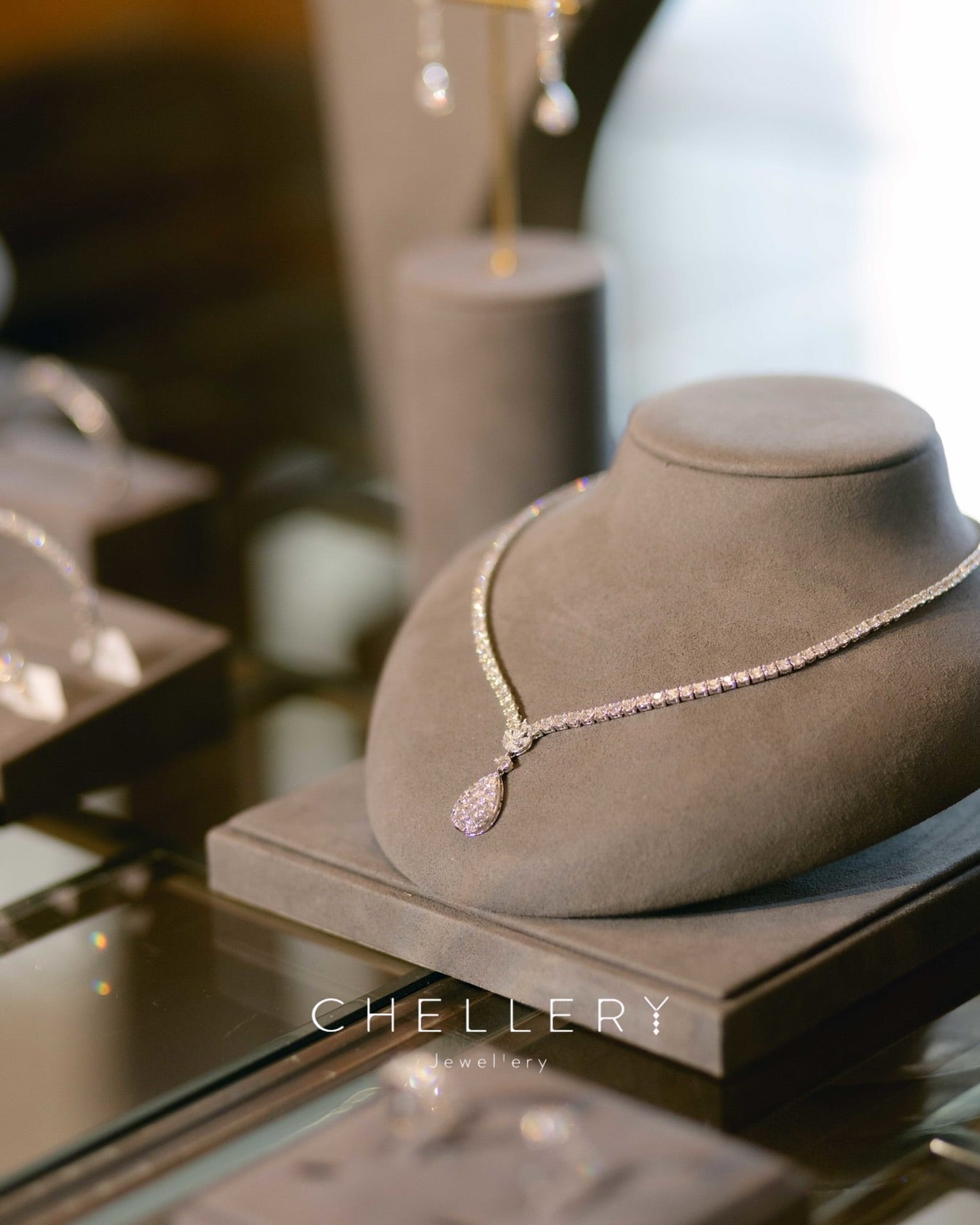 V shaped tennis necklace with pear shaped pendant